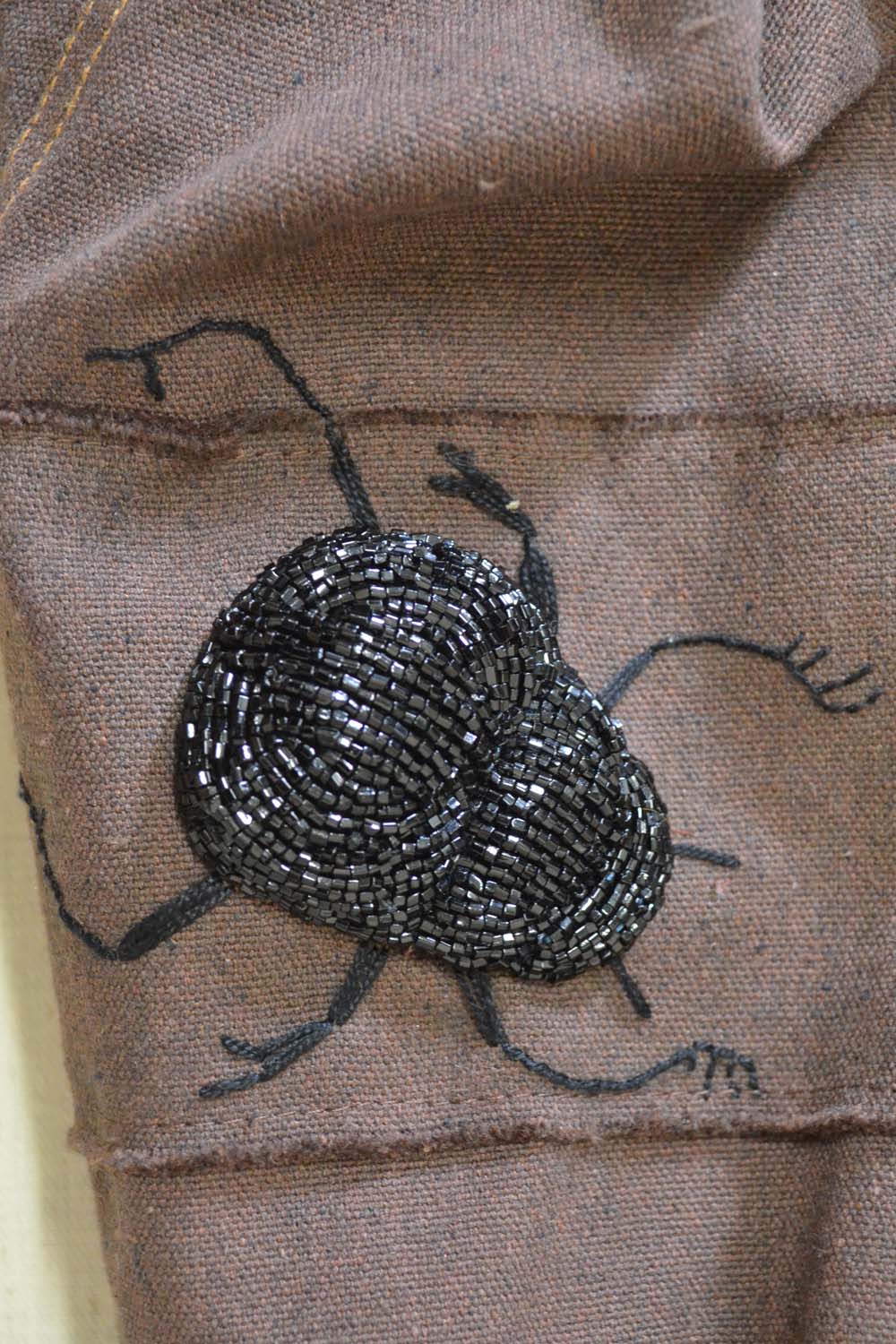 beaded dung beetle on eco friendly designer cropped jacket