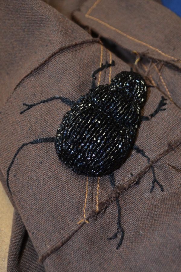 beaded dung beetle on designer womens jacket